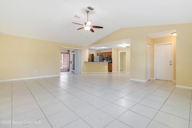 unfurnished living room featuring ceiling fan, light tile patterned floors, and vaulted ceiling