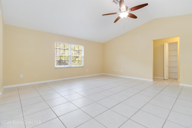 unfurnished room featuring ceiling fan, light tile patterned floors, and lofted ceiling