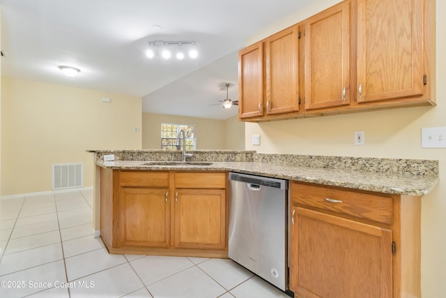 kitchen with sink, stainless steel dishwasher, ceiling fan, light tile patterned flooring, and light stone counters