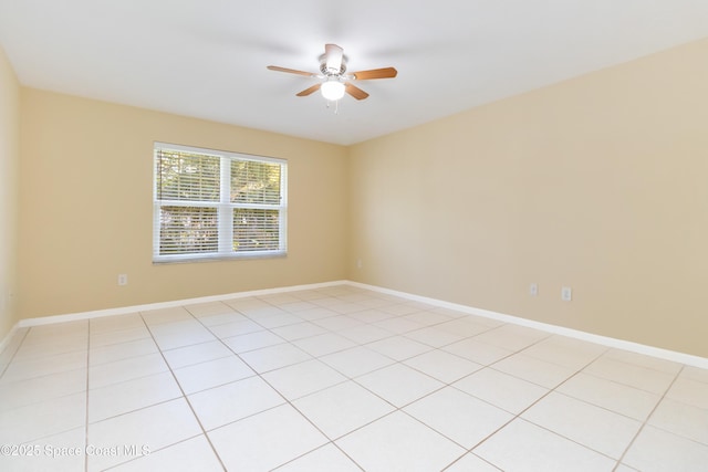 spare room featuring ceiling fan and light tile patterned floors