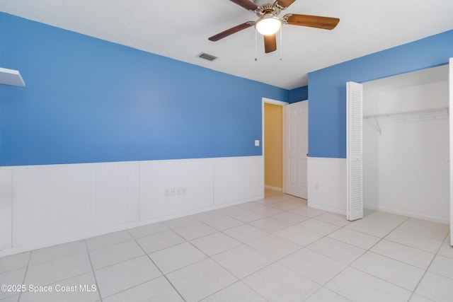 unfurnished bedroom featuring a closet, ceiling fan, and light tile patterned flooring