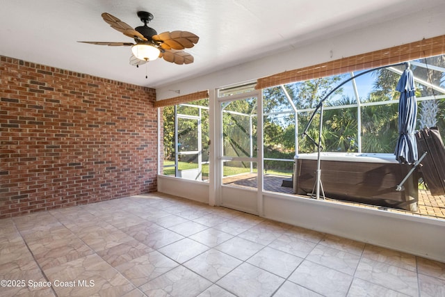 unfurnished sunroom featuring a wealth of natural light and ceiling fan