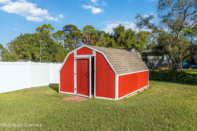 view of outdoor structure featuring a lawn