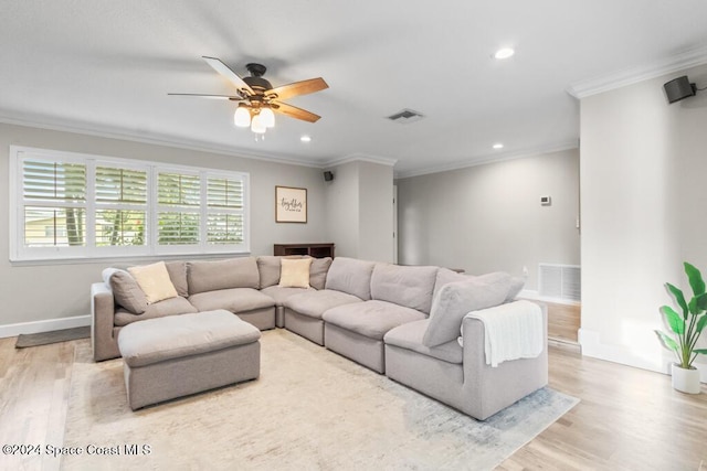 living room featuring ceiling fan, ornamental molding, and light hardwood / wood-style flooring