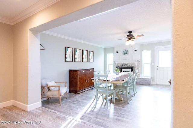 dining room featuring plenty of natural light, wood-type flooring, and ornamental molding