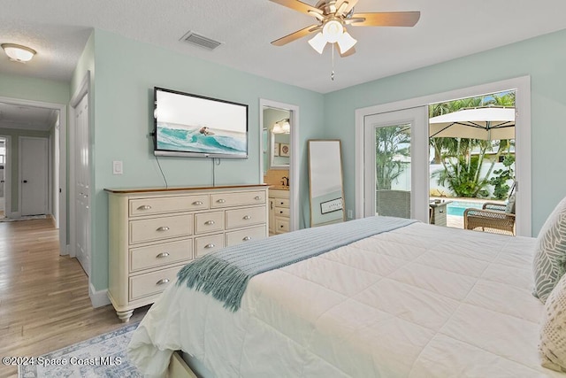 bedroom featuring connected bathroom, ceiling fan, light hardwood / wood-style flooring, a textured ceiling, and access to outside