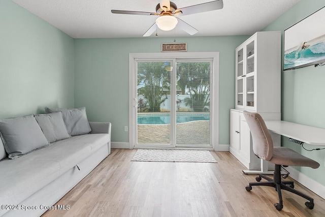 office space with ceiling fan, a textured ceiling, and light hardwood / wood-style flooring