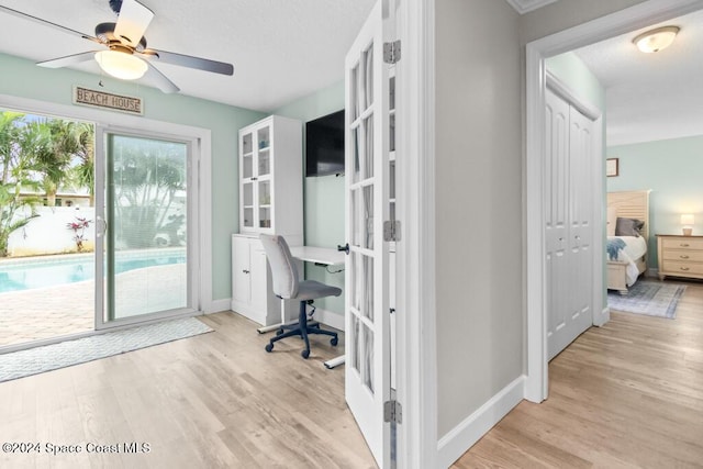 office with french doors, light wood-type flooring, and ceiling fan