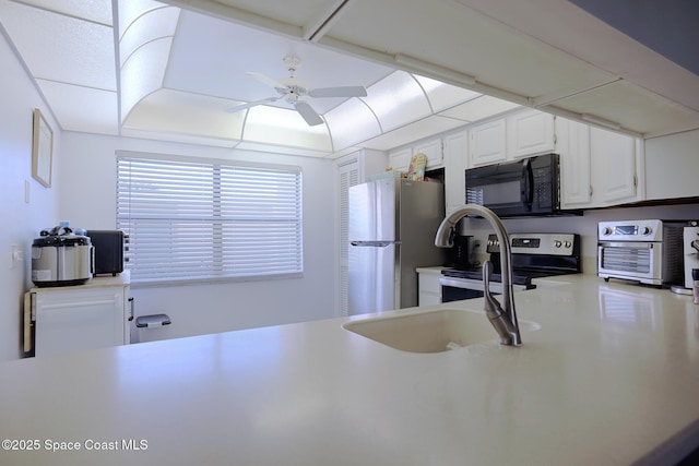 kitchen featuring appliances with stainless steel finishes, white cabinetry, and ceiling fan