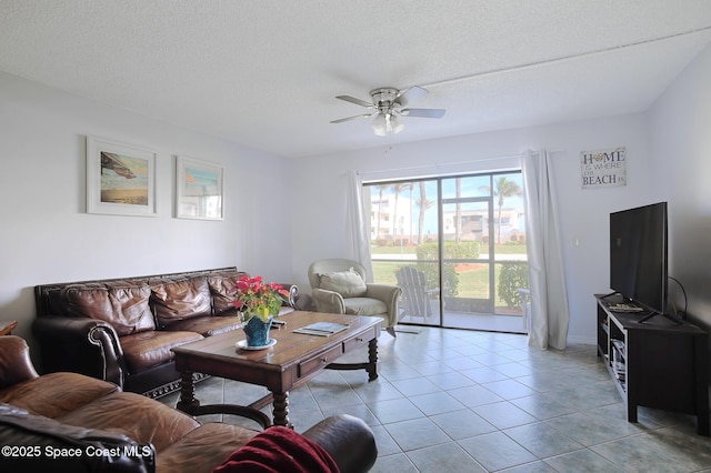 living room featuring light tile patterned floors, a textured ceiling, and ceiling fan