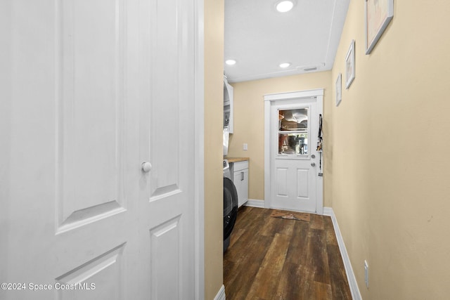 hall with dark hardwood / wood-style flooring and washer / dryer