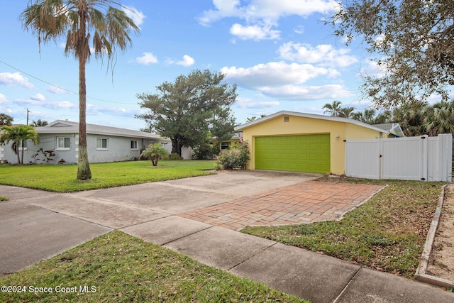 view of front of property featuring a front yard and a garage