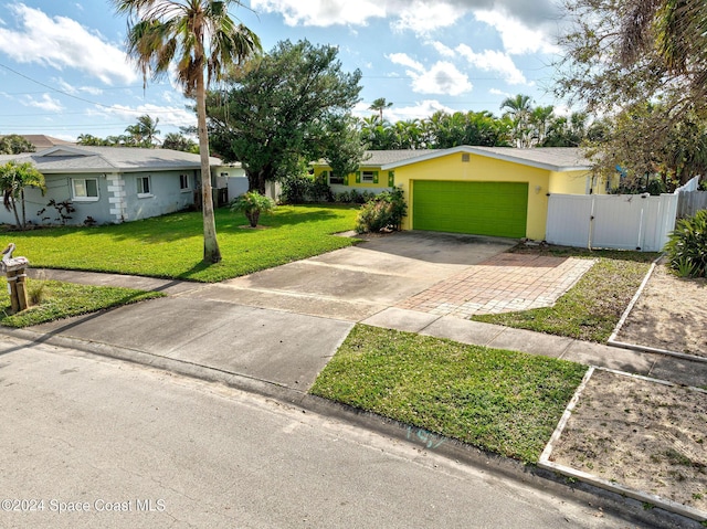 ranch-style home with a garage and a front yard