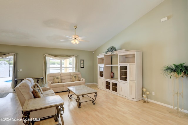 living room featuring vaulted ceiling, light hardwood / wood-style flooring, and ceiling fan