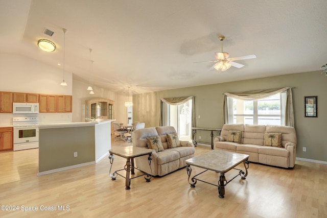 living room with ceiling fan, light wood-type flooring, and high vaulted ceiling