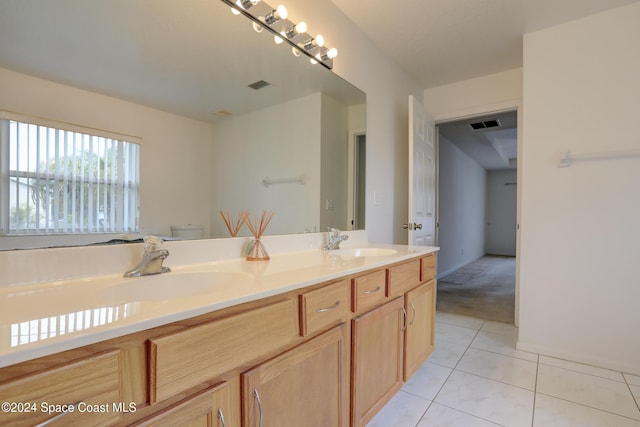 bathroom featuring tile patterned flooring, vanity, and toilet