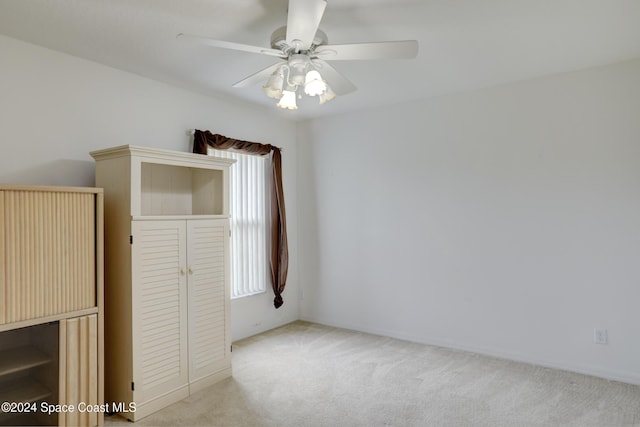 carpeted empty room with ceiling fan