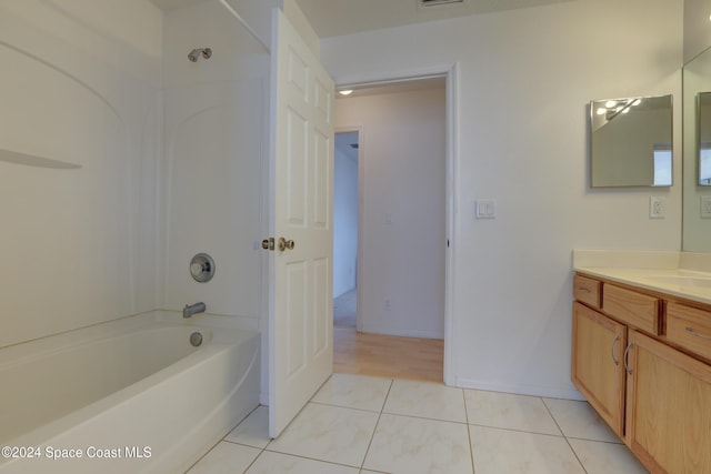 bathroom with bathtub / shower combination, vanity, and tile patterned floors