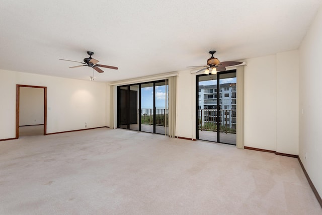 carpeted spare room with ceiling fan