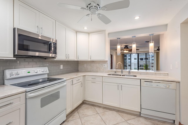 kitchen featuring white cabinets, decorative backsplash, white appliances, and sink