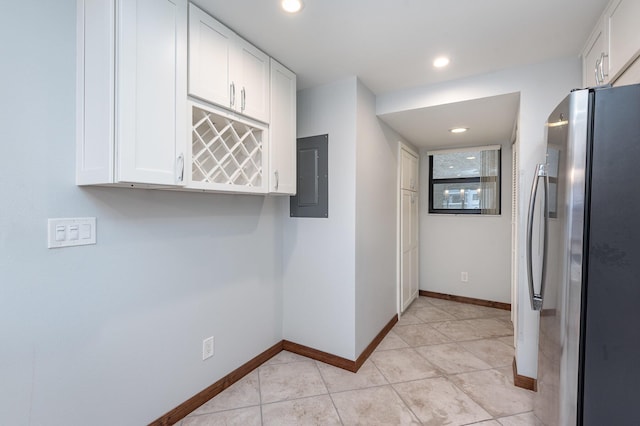 hallway with light tile patterned floors and electric panel