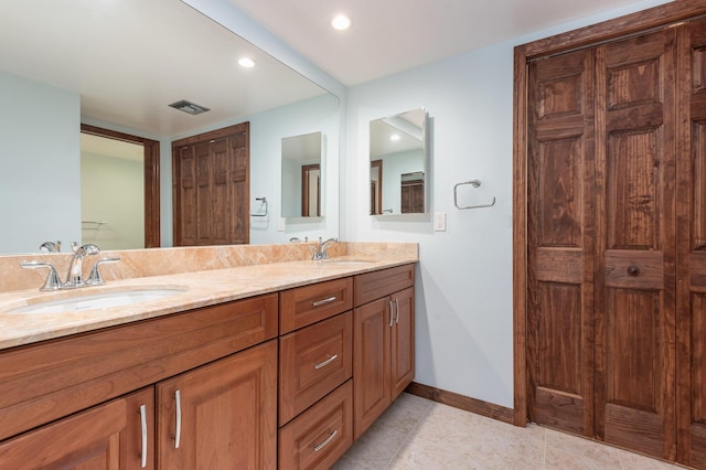 bathroom with tile patterned flooring and vanity