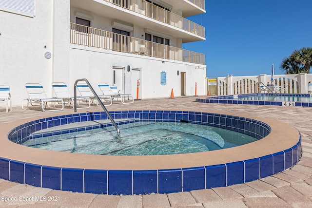 view of pool featuring a community hot tub