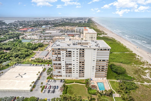 drone / aerial view with a water view and a beach view