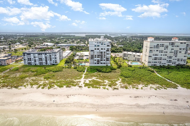 bird's eye view with a water view and a beach view