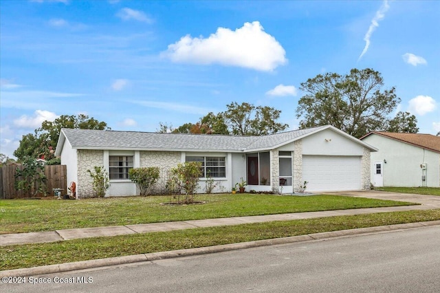 ranch-style house featuring a front yard and a garage