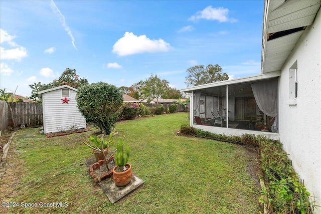 view of yard featuring a storage shed and a sunroom