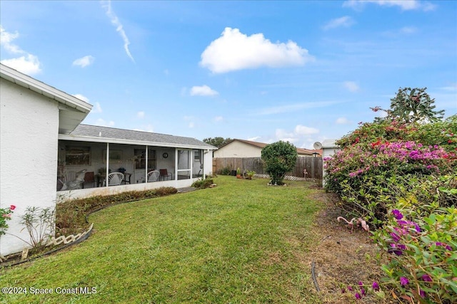 view of yard featuring a sunroom