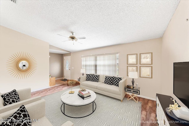 living room featuring a textured ceiling, hardwood / wood-style flooring, ceiling fan, and lofted ceiling