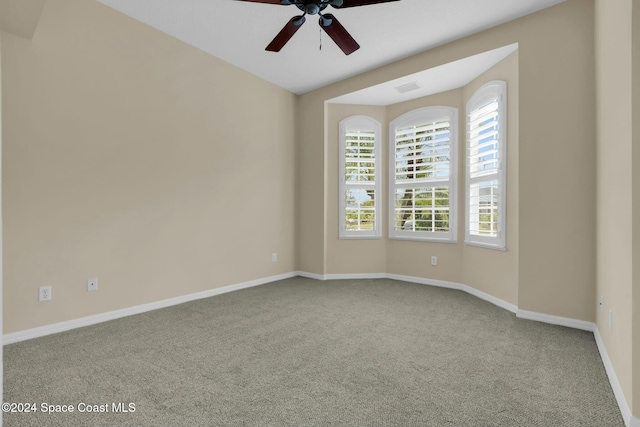 spare room featuring ceiling fan and carpet