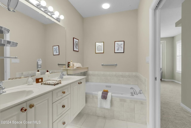 bathroom with vanity, tiled tub, and tile patterned floors