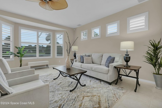 living room with light tile patterned flooring and ceiling fan