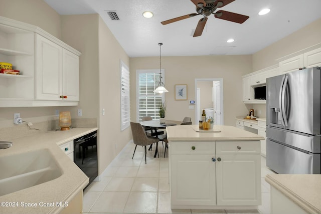 kitchen with light tile patterned flooring, decorative light fixtures, black dishwasher, white cabinets, and stainless steel fridge