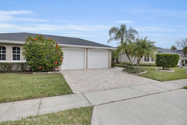 ranch-style home featuring a garage and a front yard