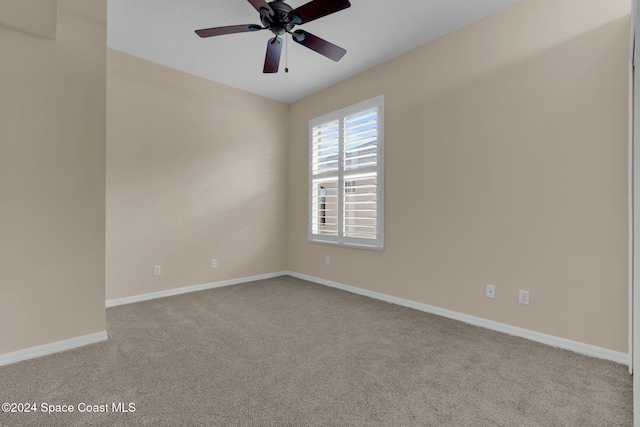 unfurnished room featuring light colored carpet and ceiling fan