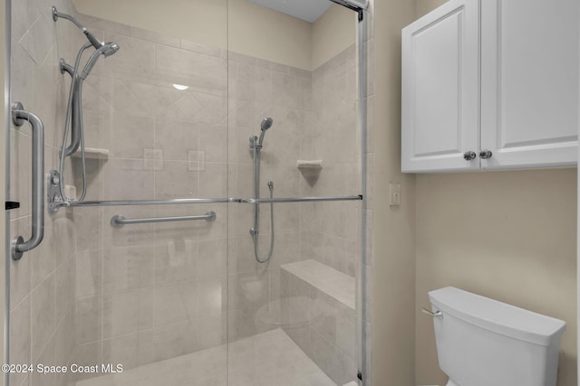 bathroom with walk in shower and toilet