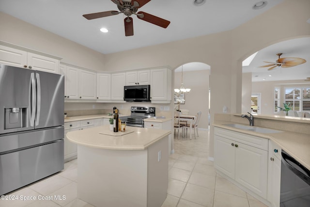 kitchen with pendant lighting, sink, light tile patterned floors, stainless steel appliances, and white cabinets