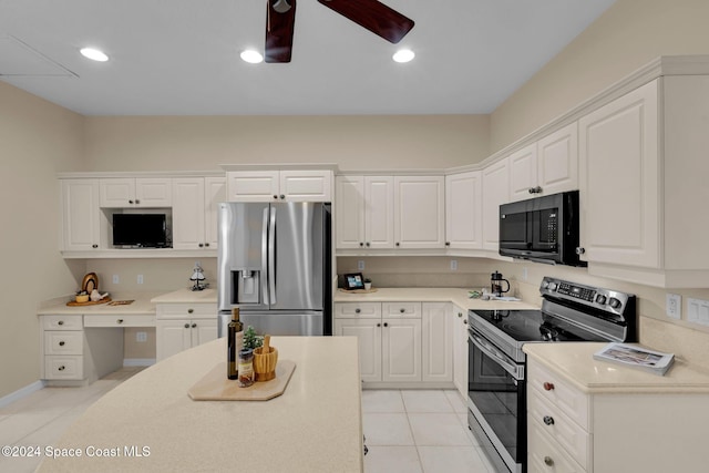 kitchen with light tile patterned floors, ceiling fan, white cabinetry, stainless steel appliances, and built in desk