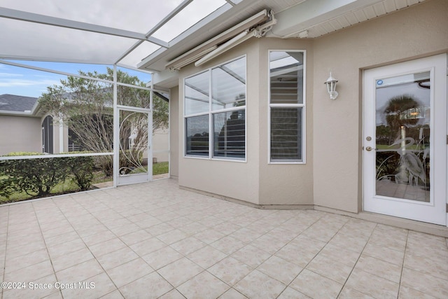 view of patio / terrace featuring a lanai