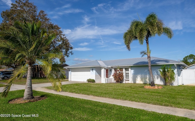 ranch-style home featuring a garage and a front lawn