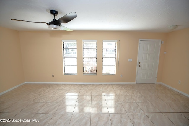 unfurnished room featuring ceiling fan and light tile patterned flooring