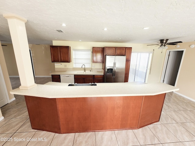 kitchen featuring white dishwasher, sink, ceiling fan, a wealth of natural light, and stainless steel fridge with ice dispenser