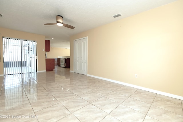 spare room with a textured ceiling and ceiling fan