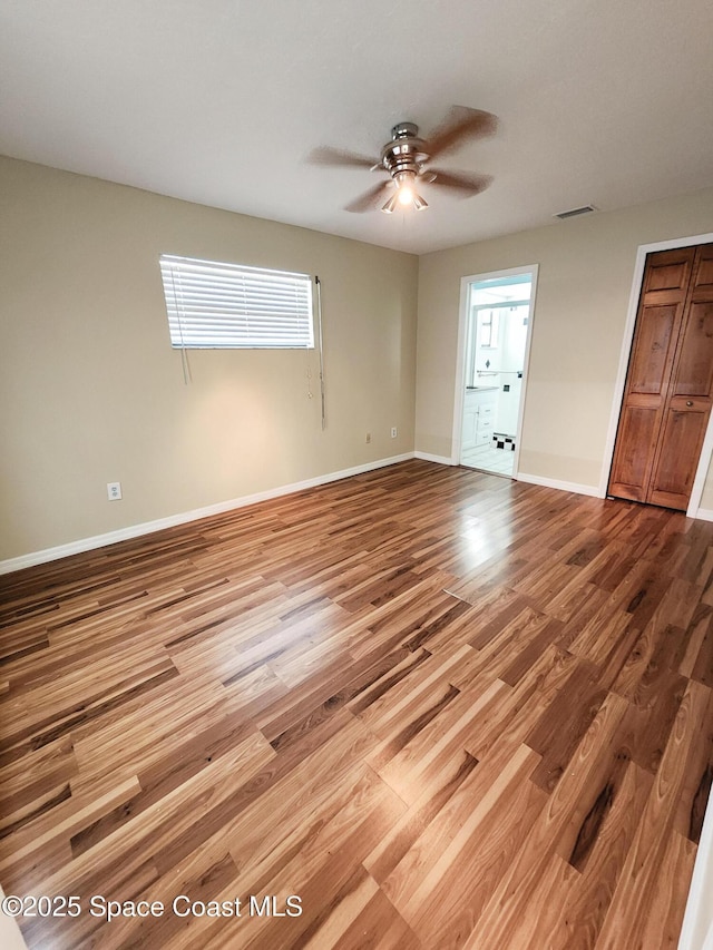 unfurnished bedroom featuring hardwood / wood-style flooring and ceiling fan