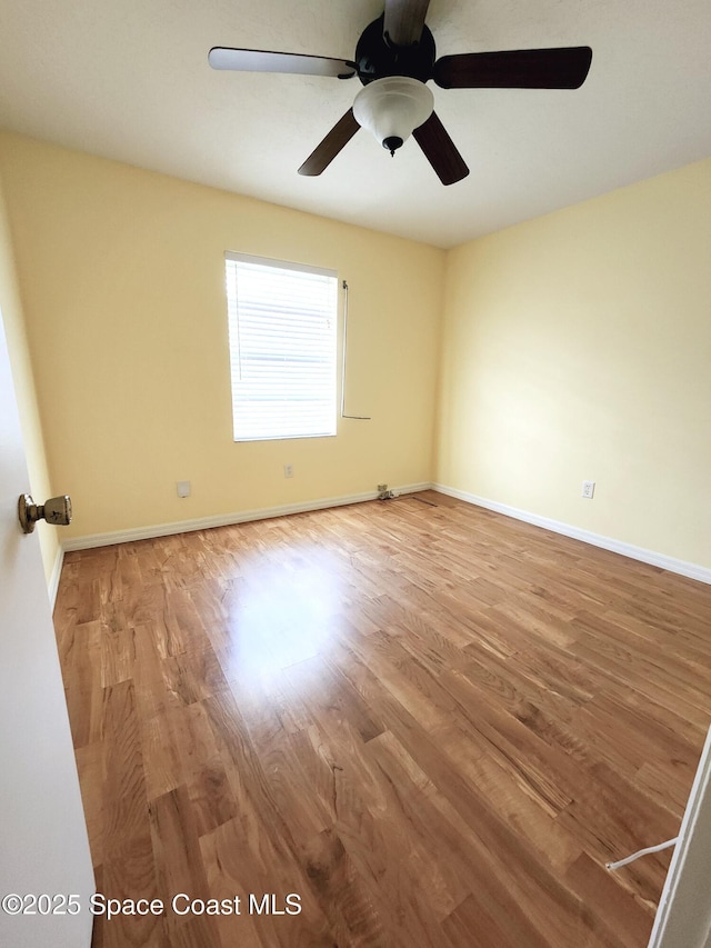 empty room featuring wood-type flooring and ceiling fan