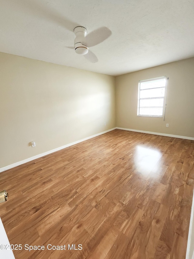 unfurnished room featuring ceiling fan and light hardwood / wood-style flooring